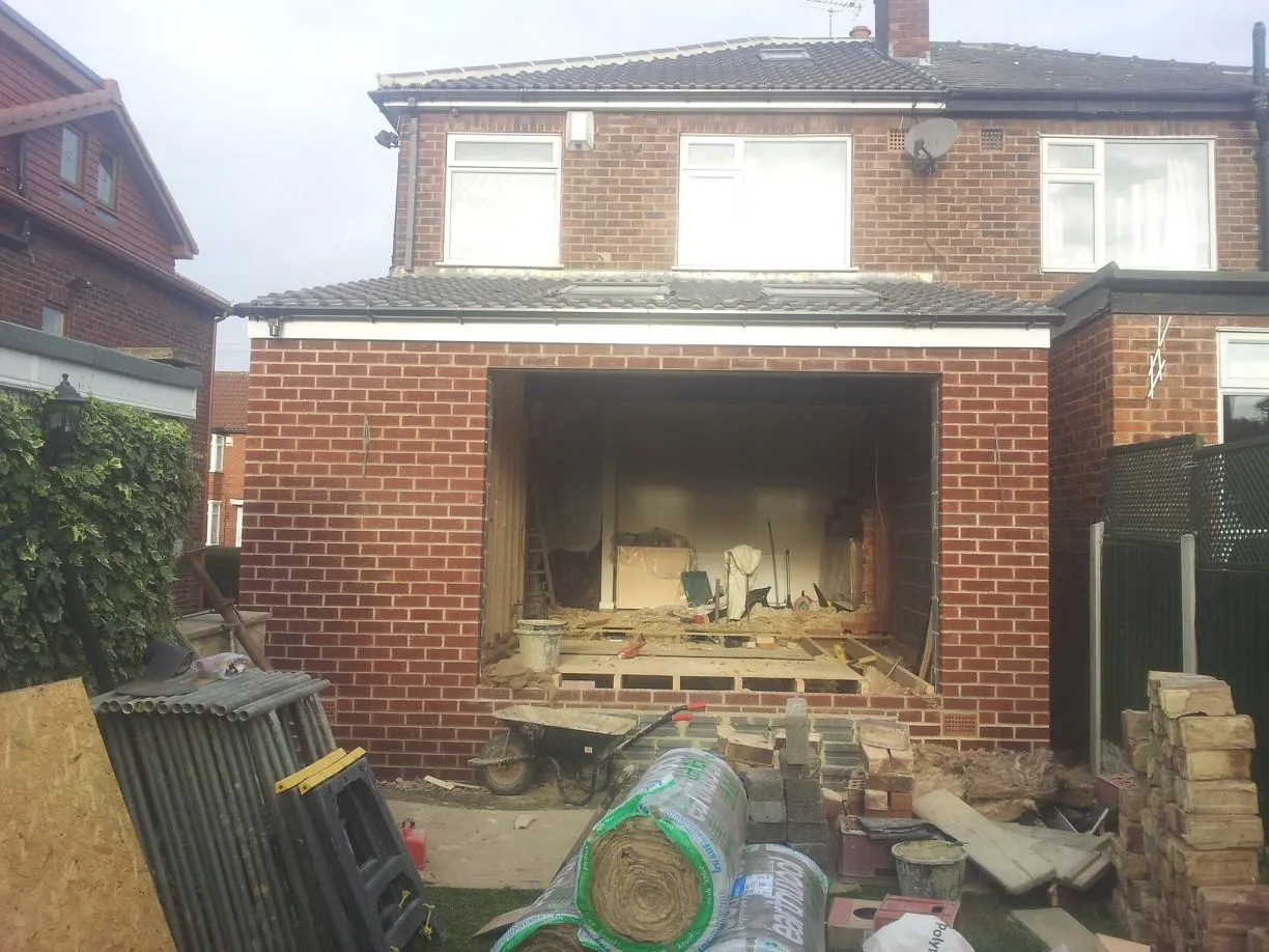 a house being built with bricks and wood
