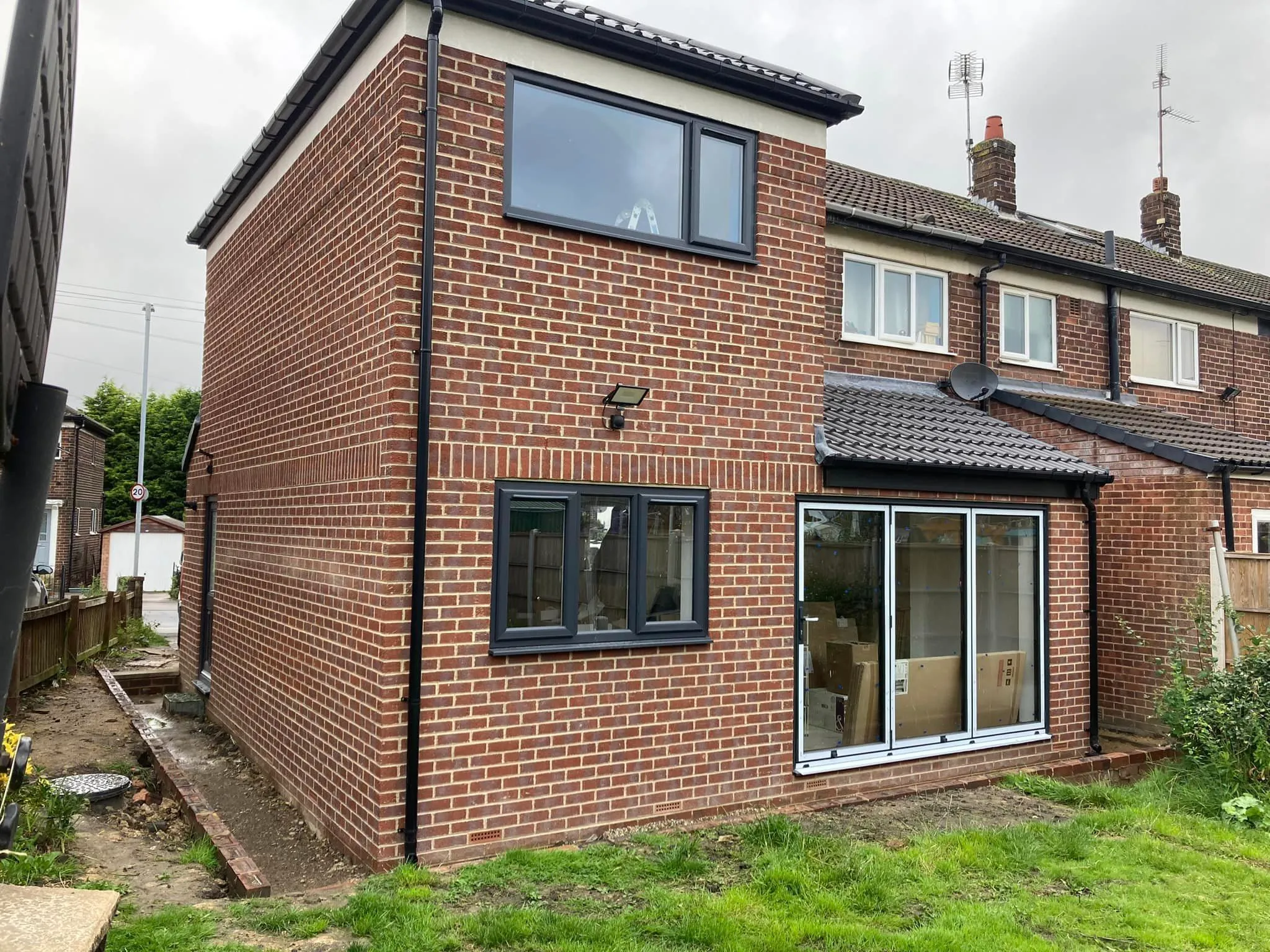 a brick house with a tiled roof and windows
