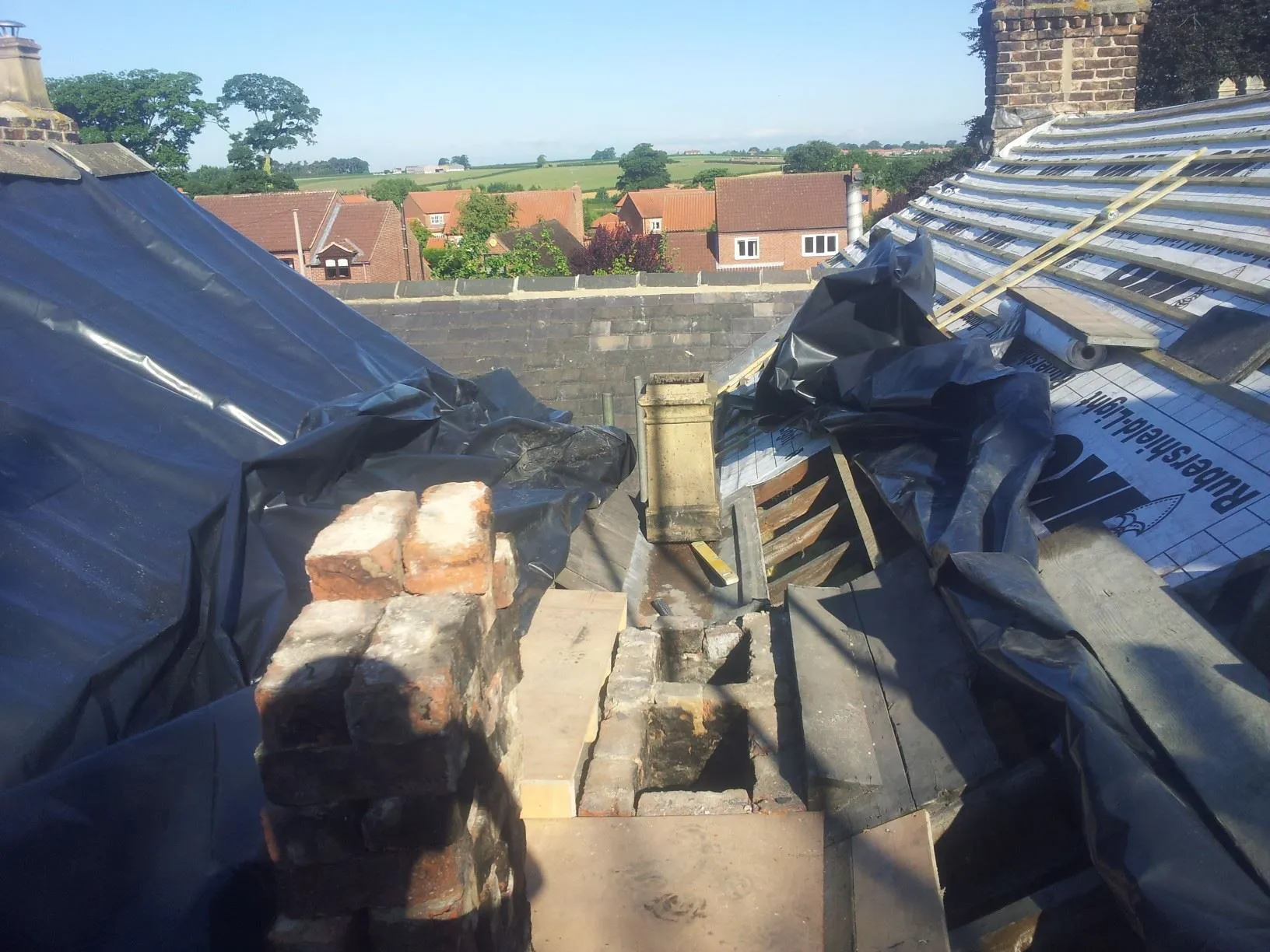 the roof of a building is covered with tarps