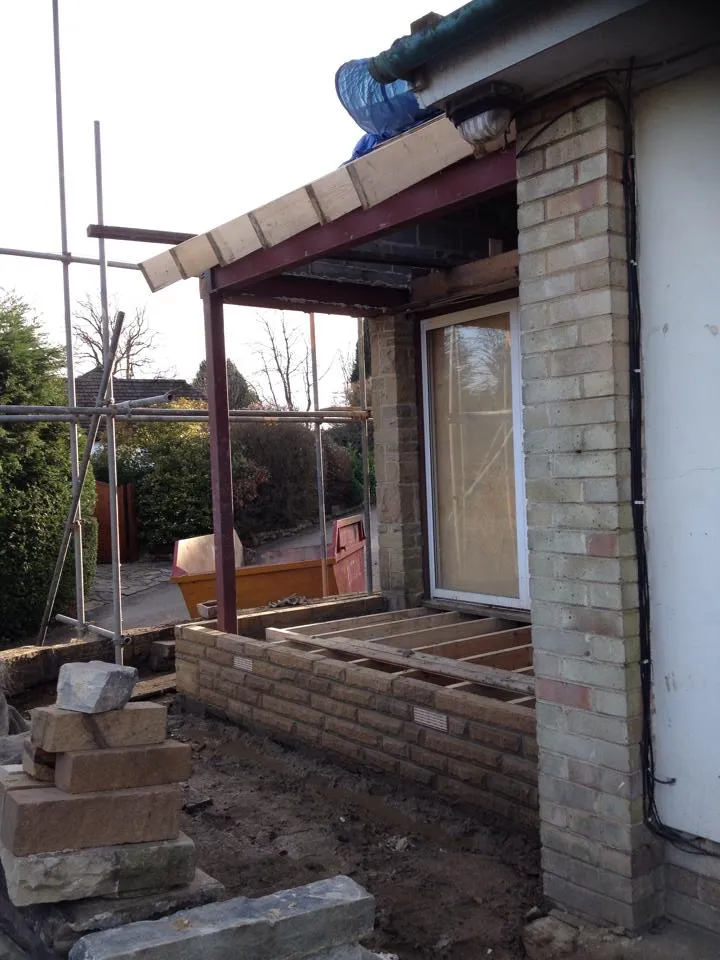 a house being built with bricks and a roof