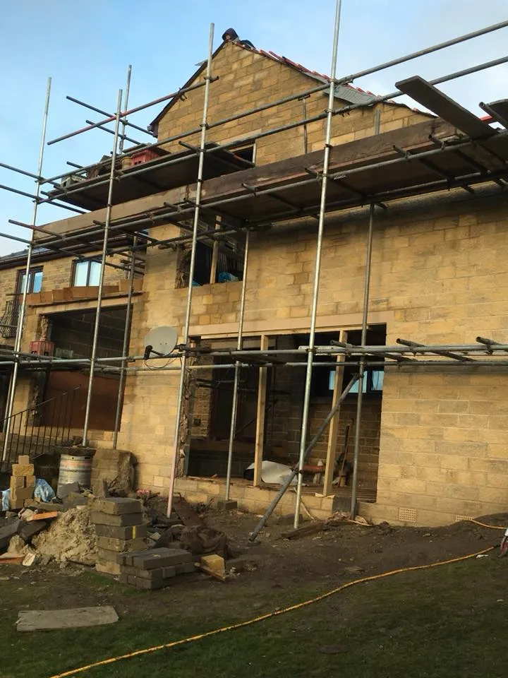 a house under construction with scaffolding around it