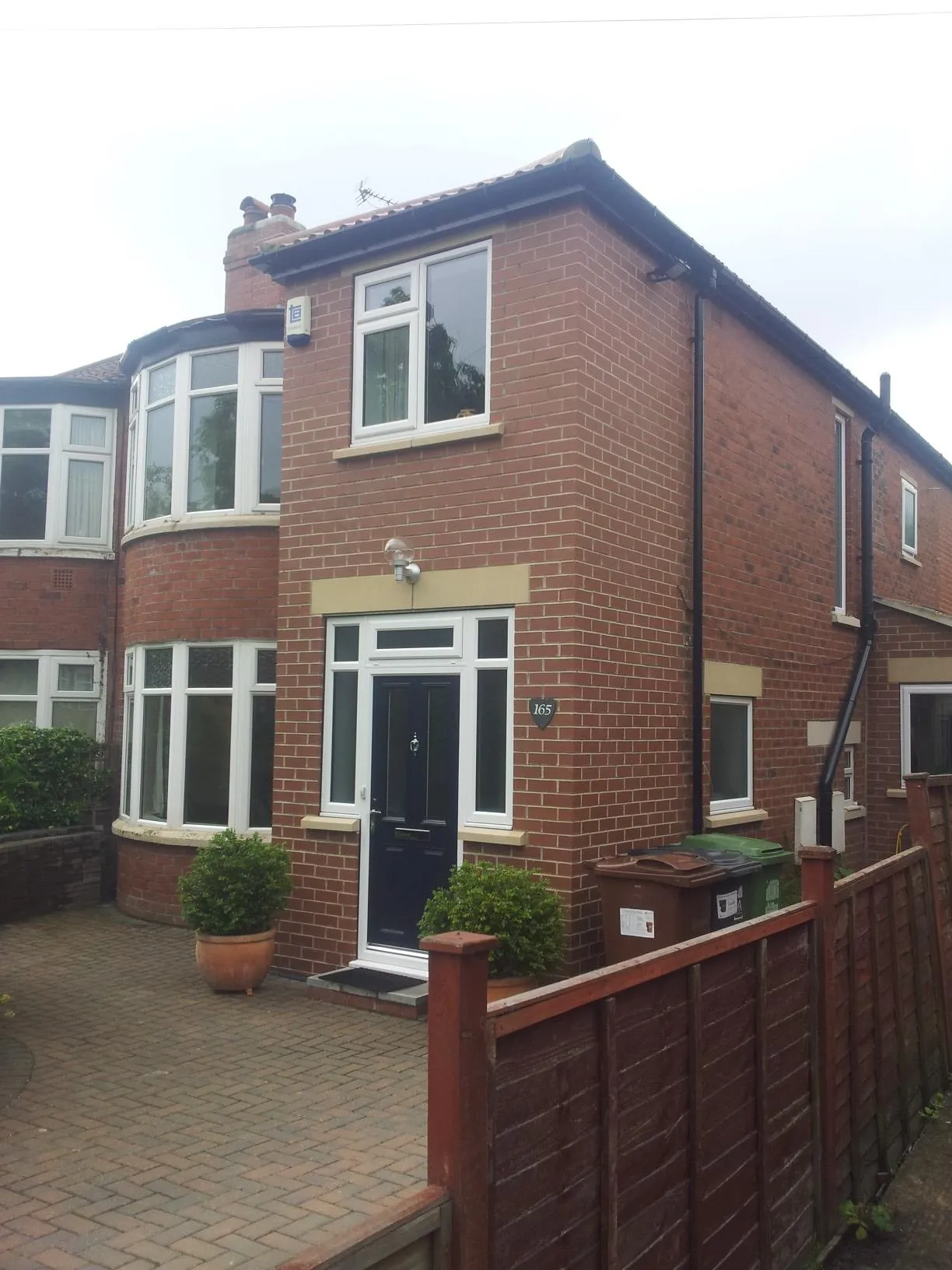 a large brick house with a fence around it